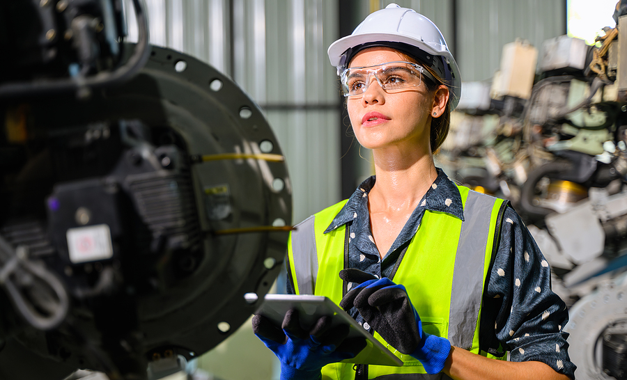 engineer checking production machining equipment